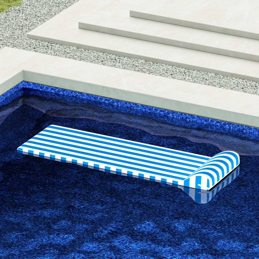 Cabana Blue pool float drifting in pool with a matching luxury liner.