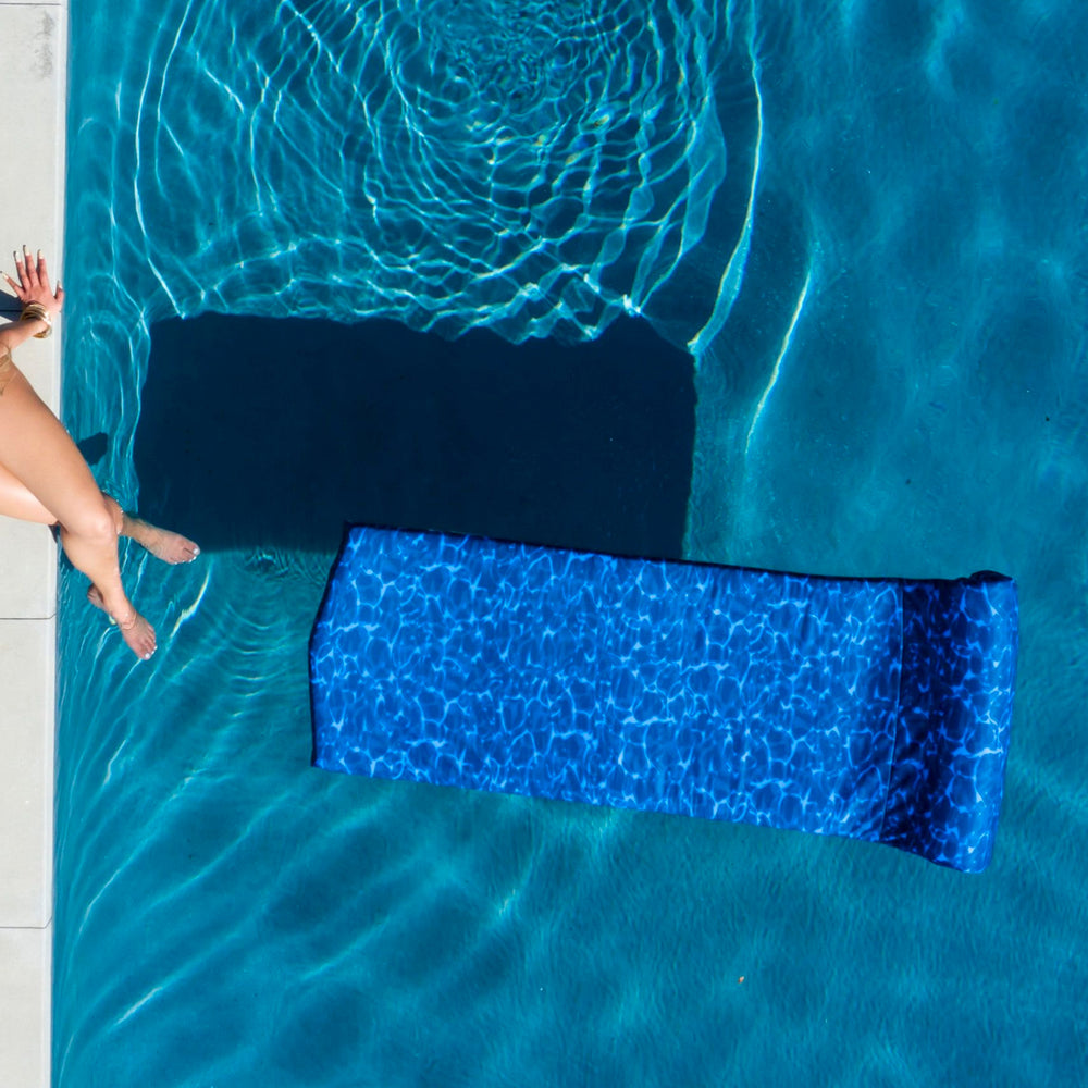 
                  
                    Load image into Gallery viewer, Woman near a stunning Indigo Seas pool float.
                  
                